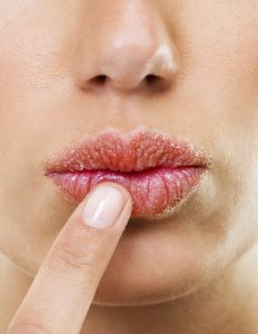 Closeup shot of a woman touching her lips