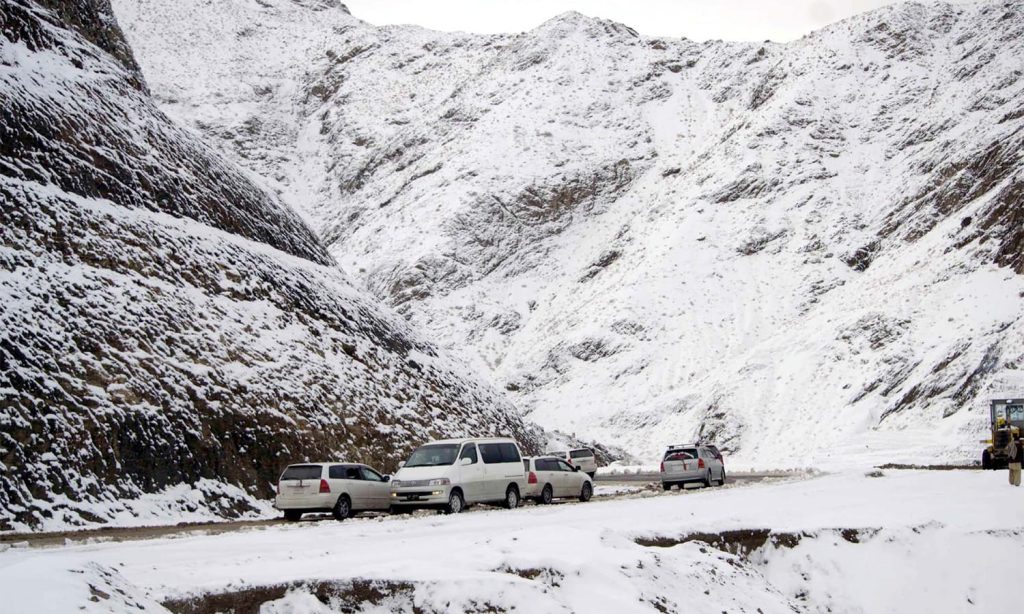 CHAMAN, PAKISTAN, DEC 09: Commuters pass through road while snow covered area after first heavy snowfall of winter season at Kozak Top in Chaman on Wednesday, December 09, 2015. (Matiullah Achakzai/PPI Images).